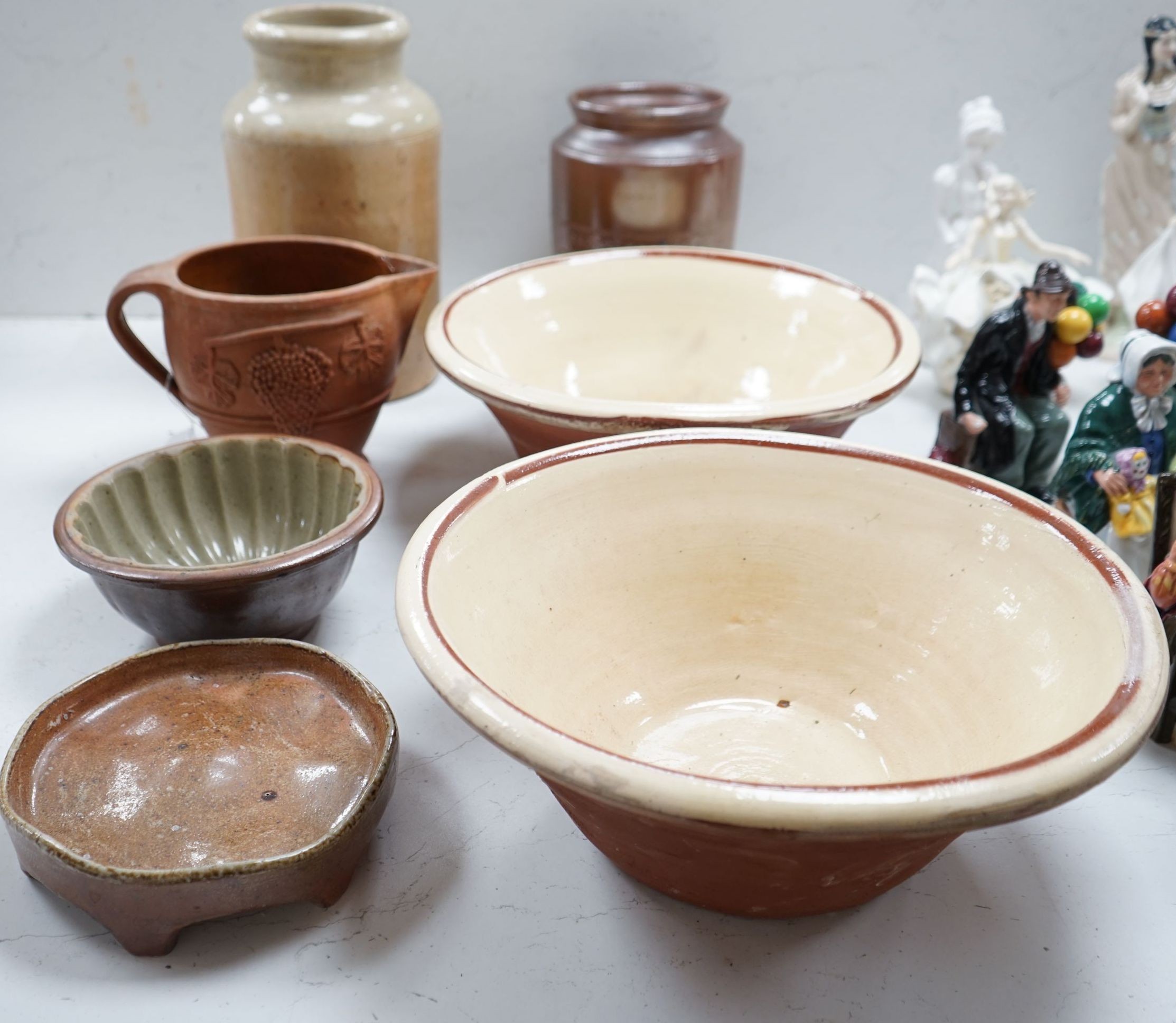 Two Victorian stoneware jars, tallest 33cm, together with two Victorian dairy bowls, a stoneware trivet, a jelly mould and a terracotta jug (7)